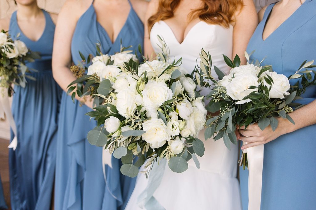 dusty blue bridesmaid dresses with white bouquets