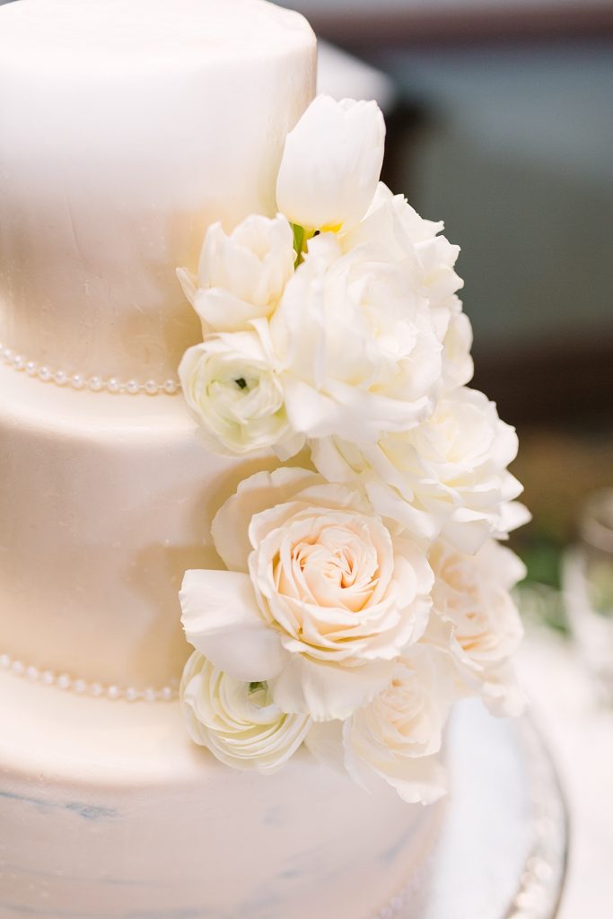 classic white wedding cake with white flowers