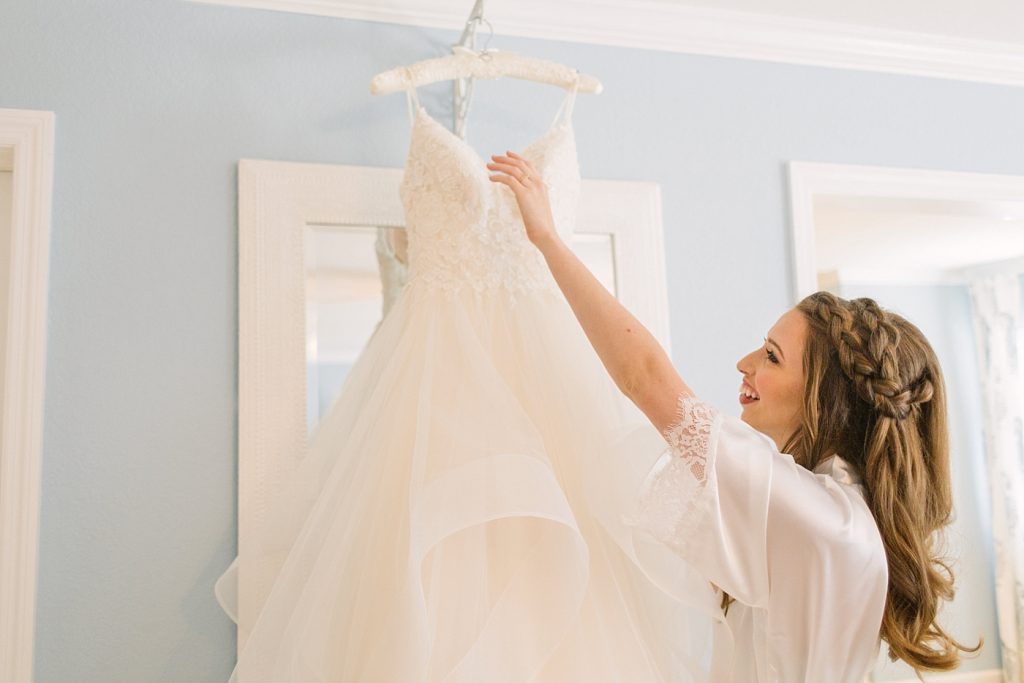bride getting ready photos with dress on hanger