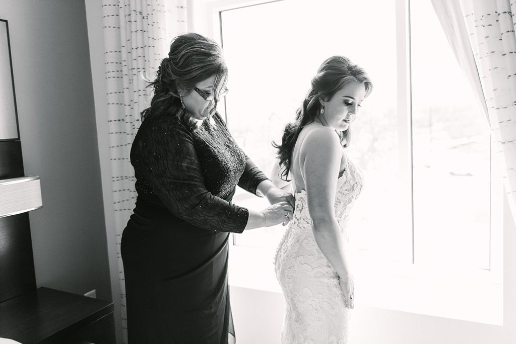 bride with mom getting ready photos on wedding day