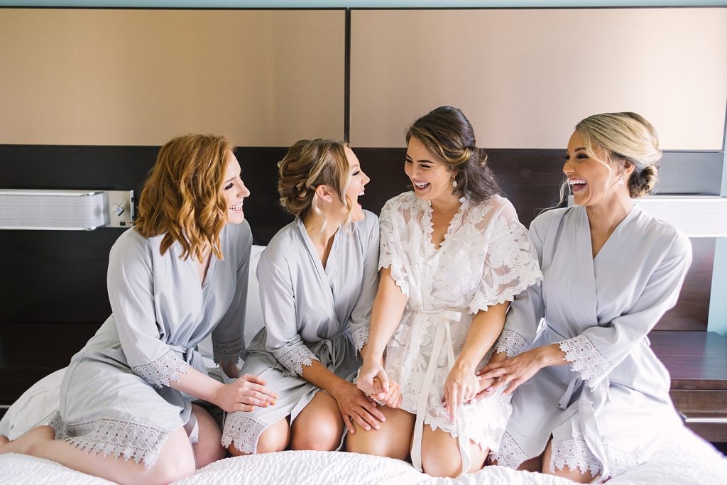 bridesmaid in robes on bed picture