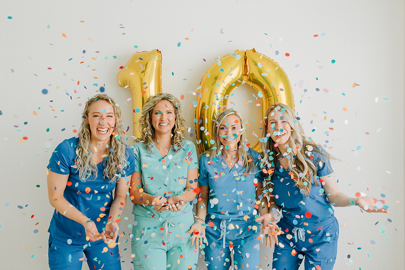 midstate skin providers throwing confetti with 10 balloons